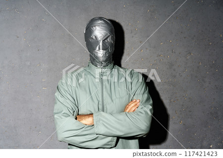 Mystery man with duct tape face wrap with crossed arms Mystery man with duct tape face wrap with crossed arms 117421423