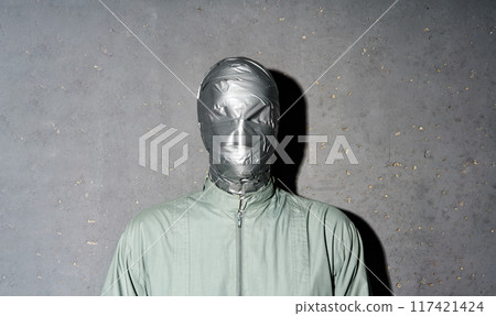 Mystery man with duct tape face wrap on gray background 117421424