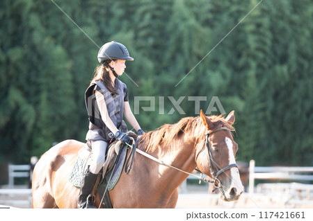 Girls enjoying horseback riding 117421661