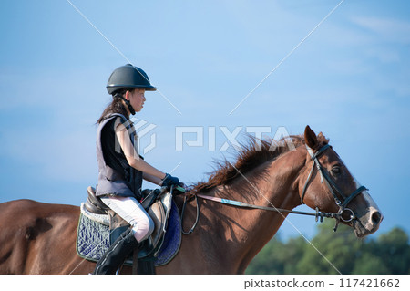 Girls enjoying horseback riding 117421662
