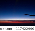 A sunset glow seen from an airplane 117422990