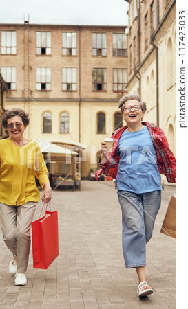 Joyful and happy seniors are enjoying a delightful day out together while shopping Joyful and happy seniors are enjoying a delightful day out together while shopping 117423033