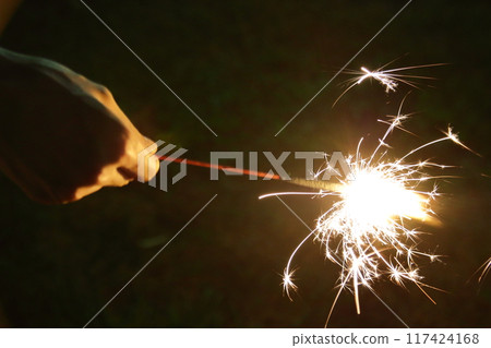 child's hand making a sparkler 117424168