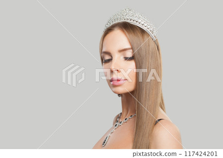 Indoor portrait of jewellery model woman wearing stylish gold necklace 117424201