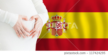Demographics, pregnancy and love baby in Spain concept. Pregnant woman making heart Demographics, pregnancy and love baby in Spain concept. Pregnant woman making heart 117424295