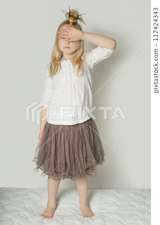 Tired young child girl standing indoor at home Tired young child girl standing indoor at home 117424343