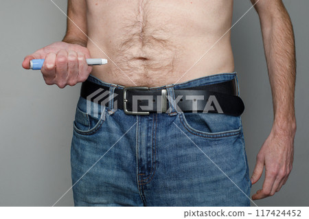 Man injecting Semaglutide Ozempic injection control blood sugar levels close up Man injecting Semaglutide Ozempic injection control blood sugar levels close up 117424452