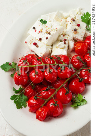 baked cherry tomatoes , with cheese, and spices, on a white plate, homemade, no people, baked cherry tomatoes , with cheese, and spices, on a white plate, homemade, no people, 117424958