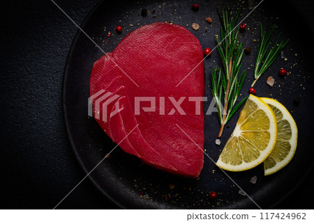 fresh red tuna fillet, for steak, raw, top view, on a black plate , no people, 117424962