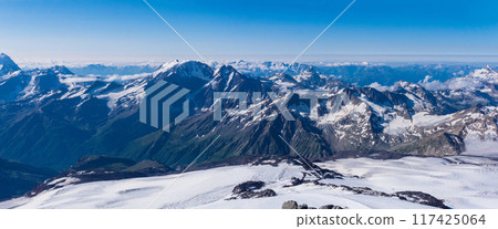 panoramic view of the high mountains above the clouds from the snowy slope of Mount Elbrus 117425064