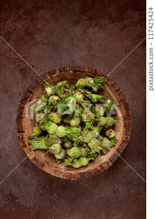 Fresh, green hazelnuts, close-up, in a wooden bowl, unpeeled, top view, no people, Fresh, green hazelnuts, close-up, in a wooden bowl, unpeeled, top view, no people, 117425424