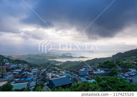 At dusk, misty mountain tops overlook coastal villages. Jiufen, Taiwan. At dusk, misty mountain tops overlook coastal villages. Jiufen, Taiwan. 117425520