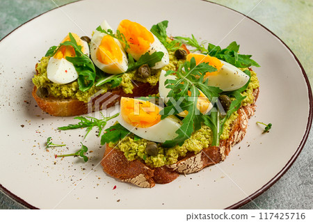 sandwich with mashed avocado, boiled egg, and arugula, on bread , homemade, breakfast, 117425716