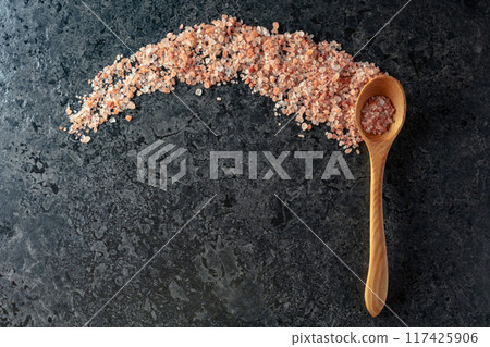 Pink himalayan salt on a black stone background. Pink himalayan salt on a black stone background. 117425906