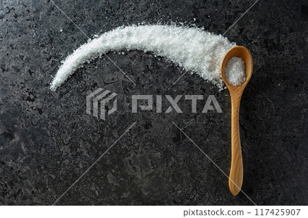 Sea salt on a black stone background. 117425907