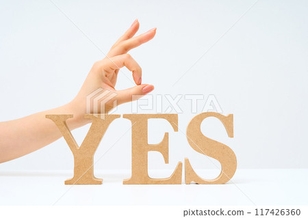 Wooden alphabet blocks arranged to spell out "YES" 117426360