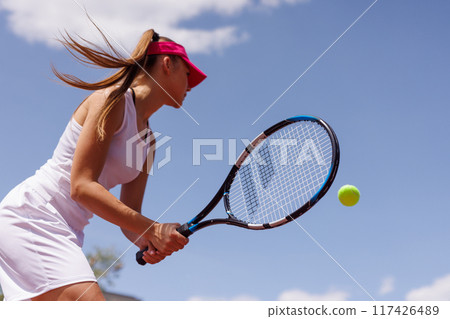 young woman playing tennis on the tennis court, olympic sport 117426489