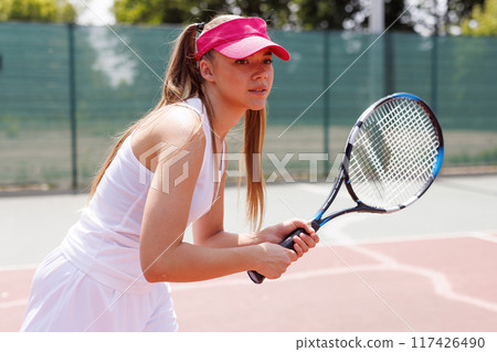 young woman playing tennis on the tennis court, olympic sport young woman playing tennis on the tennis court, olympic sport 117426490