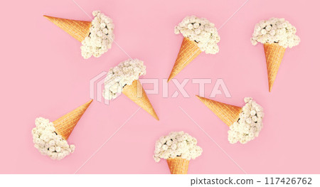 Many ice cream cone with flowers on colorful pink background, flat lay, creative modern print 117426762
