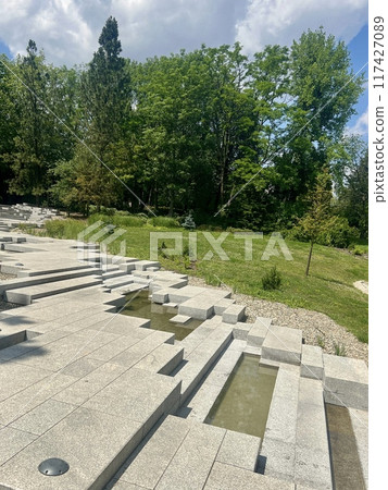Stone steps in the park on a sunny summer day.  117427089