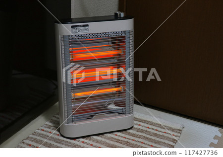 Electric heater in use (three-heater type, on a cloth mat) Electric heater in use (three-heater type, on a cloth mat) 117427736