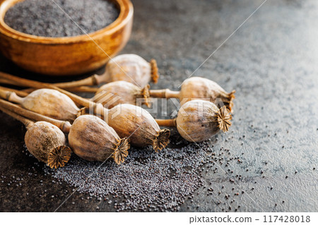 Dry poppy seed and poppy head on kitchen table. Dry poppy seed and poppy head on kitchen table. 117428018