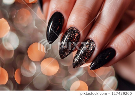 Female hand with black nail design. Glitter nail polish manicure. 117429260
