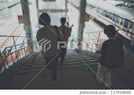 People descending the stairs at the station 117429600