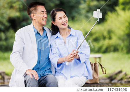 Senior couple taking a selfie with a smartphone 117431698