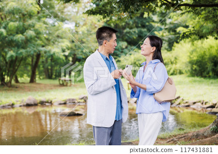 Senior couple looking at smartphone Second Life 117431881