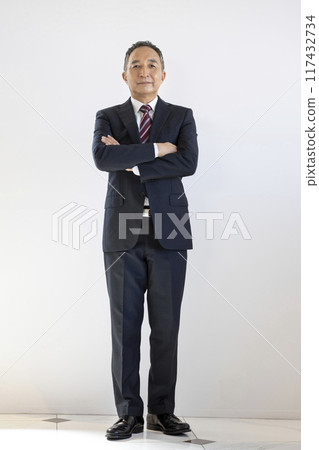 A businessman in his 60s with his arms folded A businessman in his 60s with his arms folded 117432734