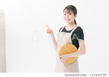 Female cafe staff wearing an apron 117432776
