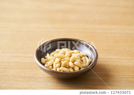 Pine nuts on a small plate 117433071