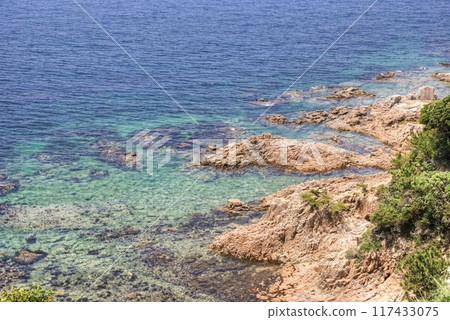 Calm sea in the shadow of the mountains Calm sea in the shadow of the mountains 117433075