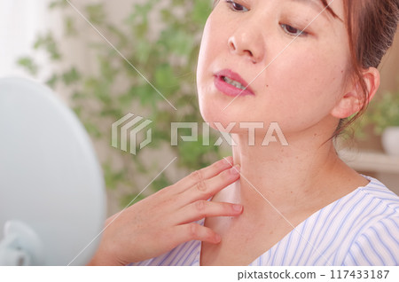 A woman who is concerned about the corridor around her neck A woman who is concerned about the corridor around her neck 117433187