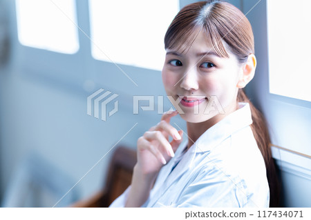 Female doctor wearing white coat Female doctor wearing white coat 117434071