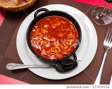 Portion of stewed tripe is cooked in plate - stomach of cattle 117434158