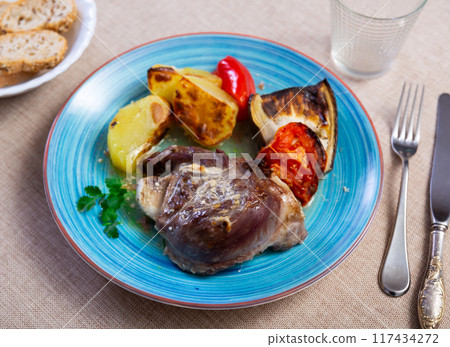 Baked pork cheek served with vegetables 117434272