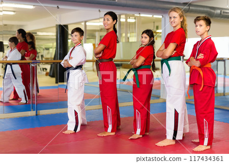 Group photo of kids and karate trainer in gym 117434361