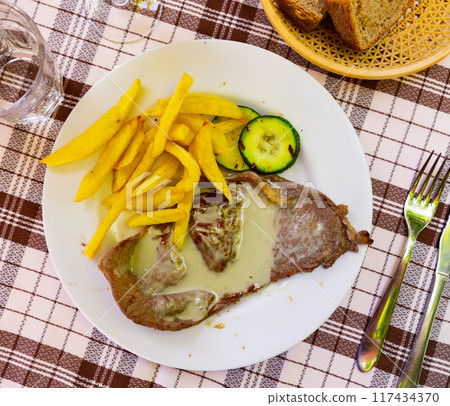 Steak with roquefort sauce with potatoes and zucchini Steak with roquefort sauce with potatoes and zucchini 117434370