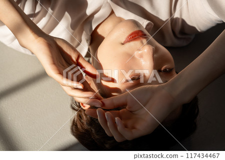 Middle-aged woman lying on floor 117434467