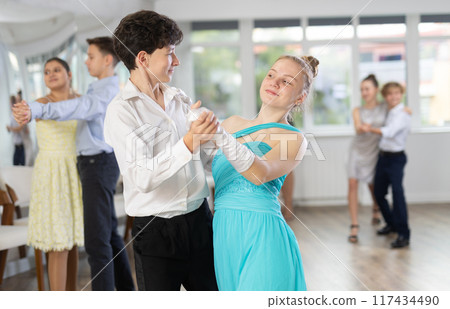 Viennese Waltz performed by teenage girls and boys in dance studio 117434490