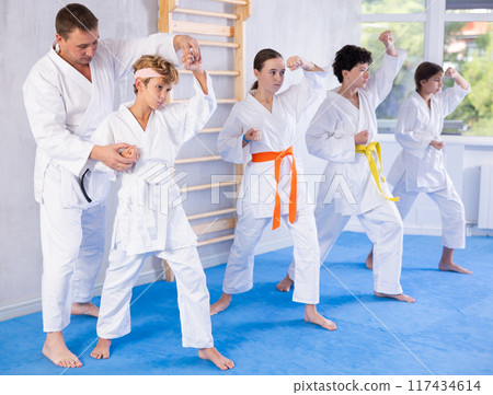 Group of children train karate techniques 117434614
