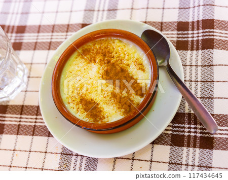 Rice pudding. Sweet dish made by cooking rice in milk and sugar, some recipes include vanilla 117434645