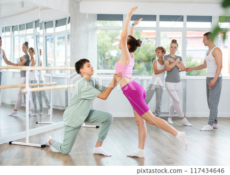 Ballet studio - teenagers girls and boys learn ballet movements in pairs Ballet studio - teenagers girls and boys learn ballet movements in pairs 117434646