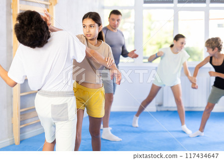 Boy and girl practicing self-defense techniques 117434647