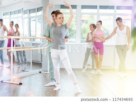 Ballet training for teenagers in a ballet studio under the guidance of choreographer 117434693