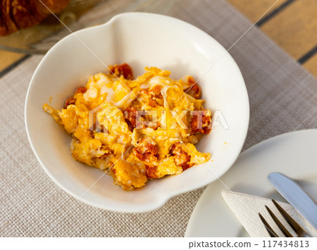 Huevos con chistorra - fried eggs with sausages served closeup 117434813