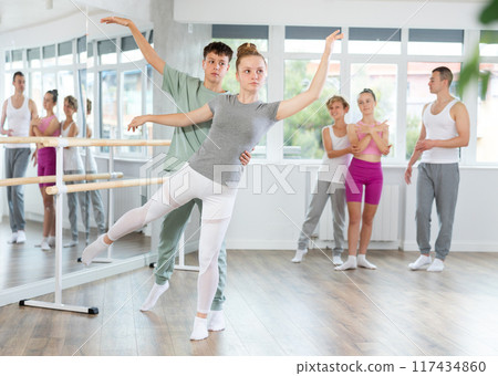 Ballet training for teenagers in a ballet studio under the guidance of choreographer Ballet training for teenagers in a ballet studio under the guidance of choreographer 117434860