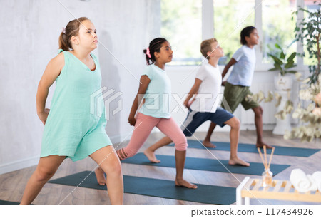 Young girl doing pilates in group of children 117434926